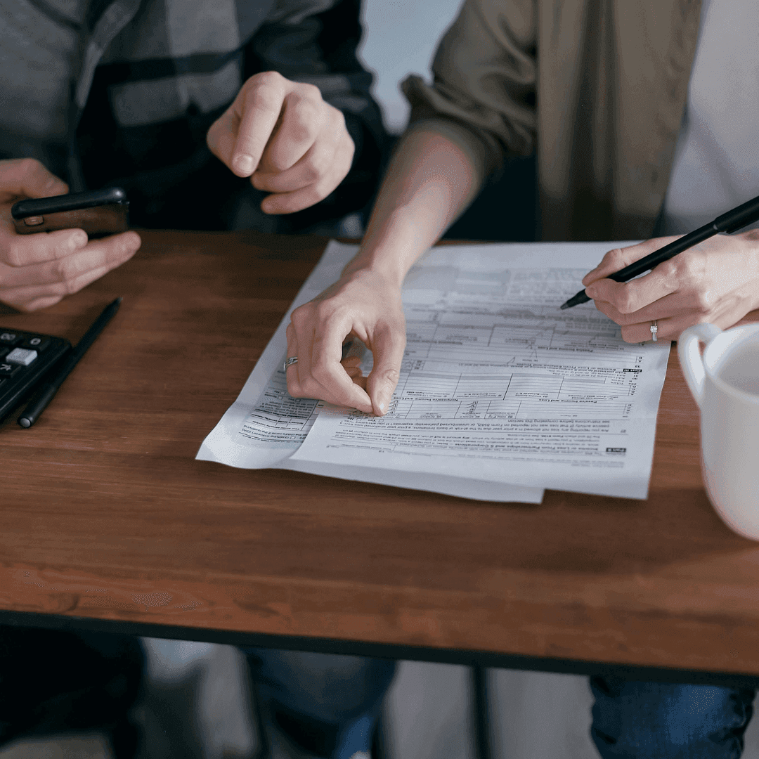 conveyancing pros couple signing papers and making phone call