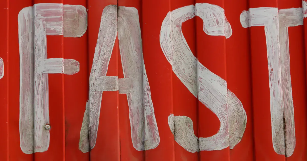 word fast spelled with pain on red background