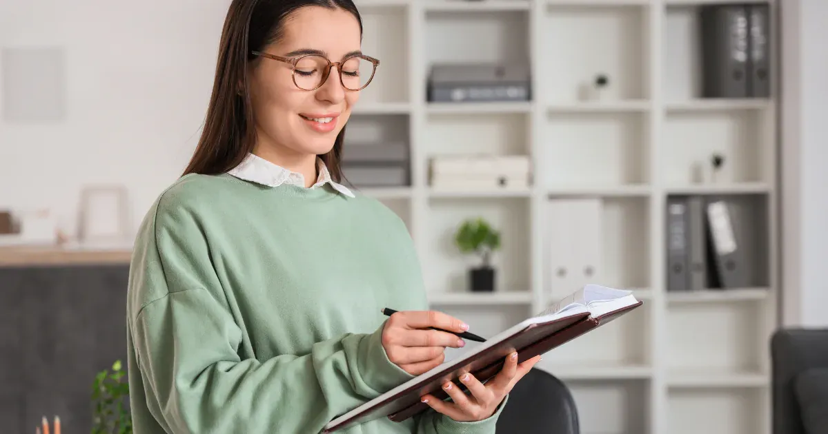 woman reading and writing a report