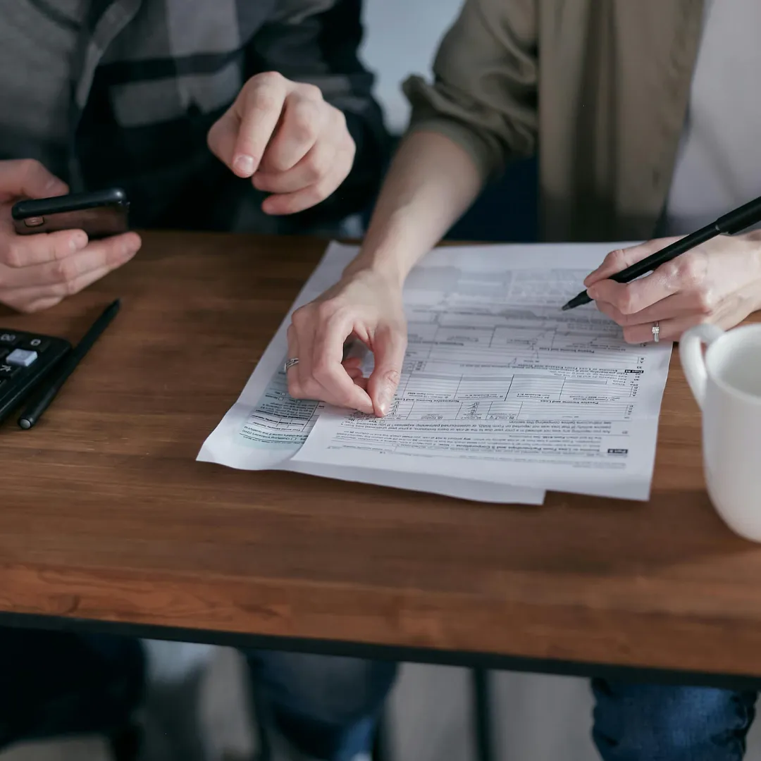 conveyancing pros couple signing papers and making phone call