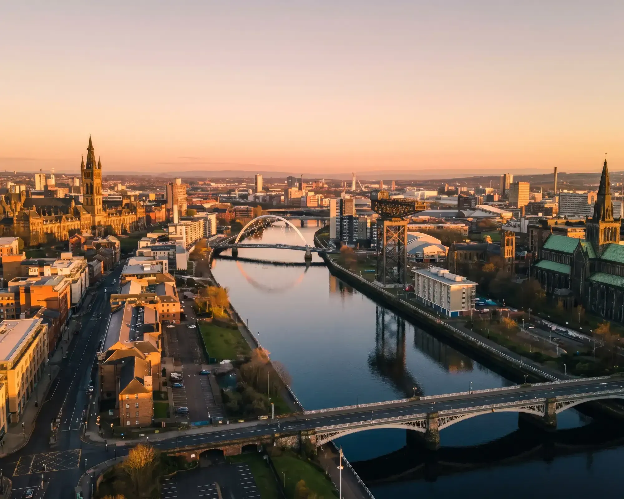 Aerial view of Glasgow city skyline and the River Clyde at sunset, home to our conveyancing solicitors