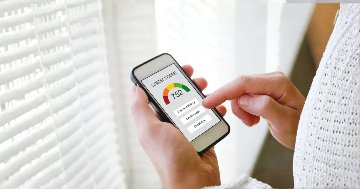 A person looking at their credit score on a mobile phone.