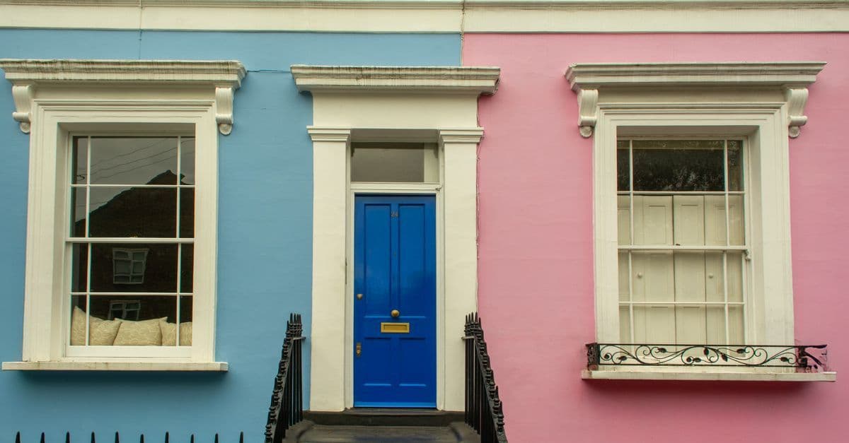 Vibrant blue and pink facade of a Georgian-style townhouse in London.