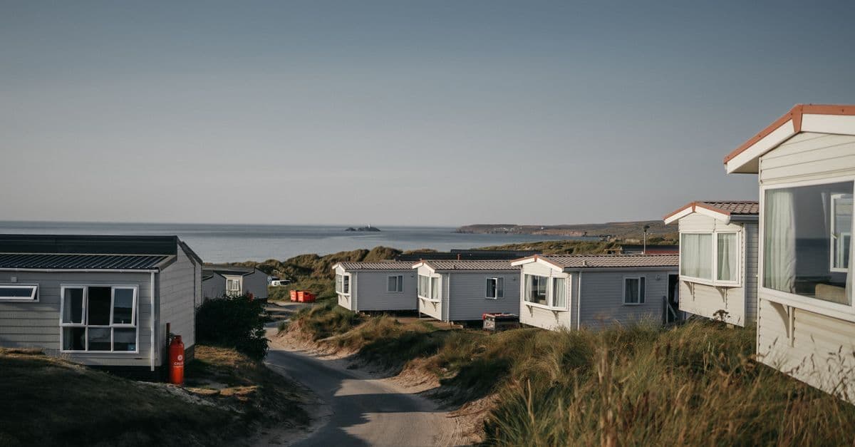 Tranquil seaside view of static caravans by the coast during summer.