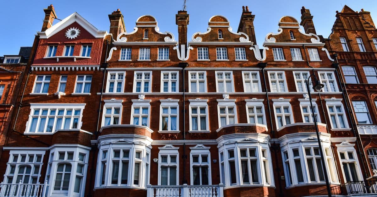 Victorian-style red brick building in London with ornate windows and detailed facade.