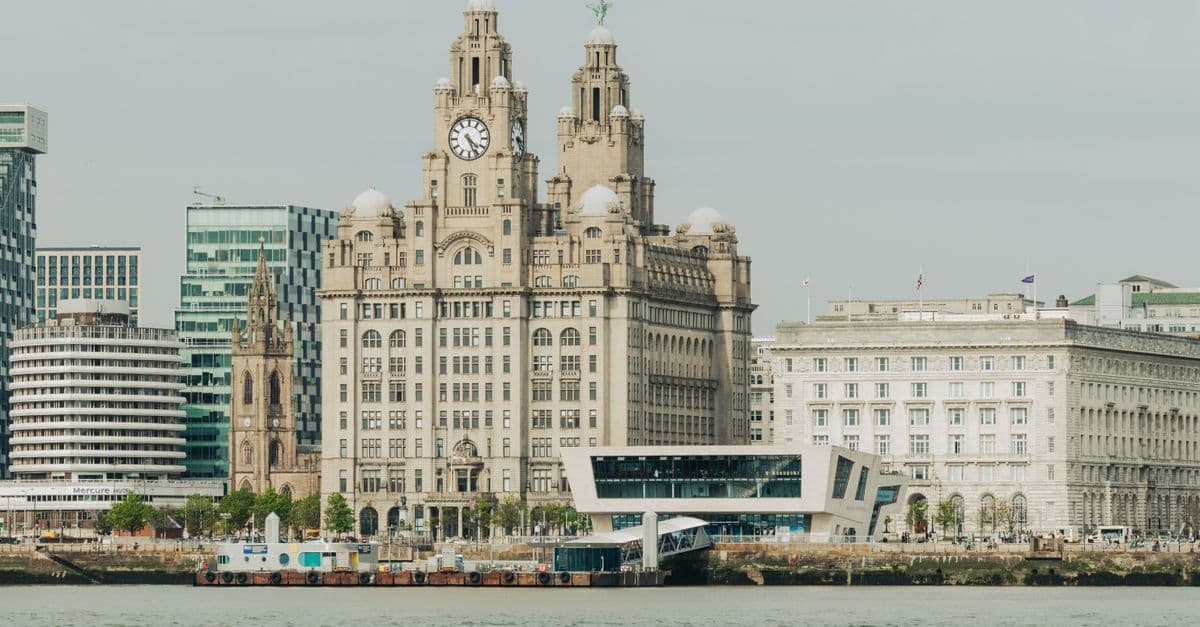 Scenic view of Liverpool's Royal Liver Building at the waterfront, showcasing architectural elegance.