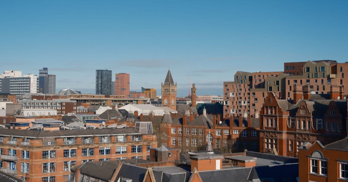 A vibrant view of Manchester showcasing modern and classic architecture under a clear sky.