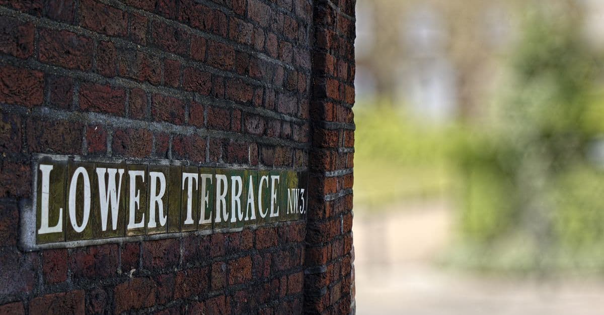 Close-up of the 'Lower Terrace NW3' sign on a brick wall in London.