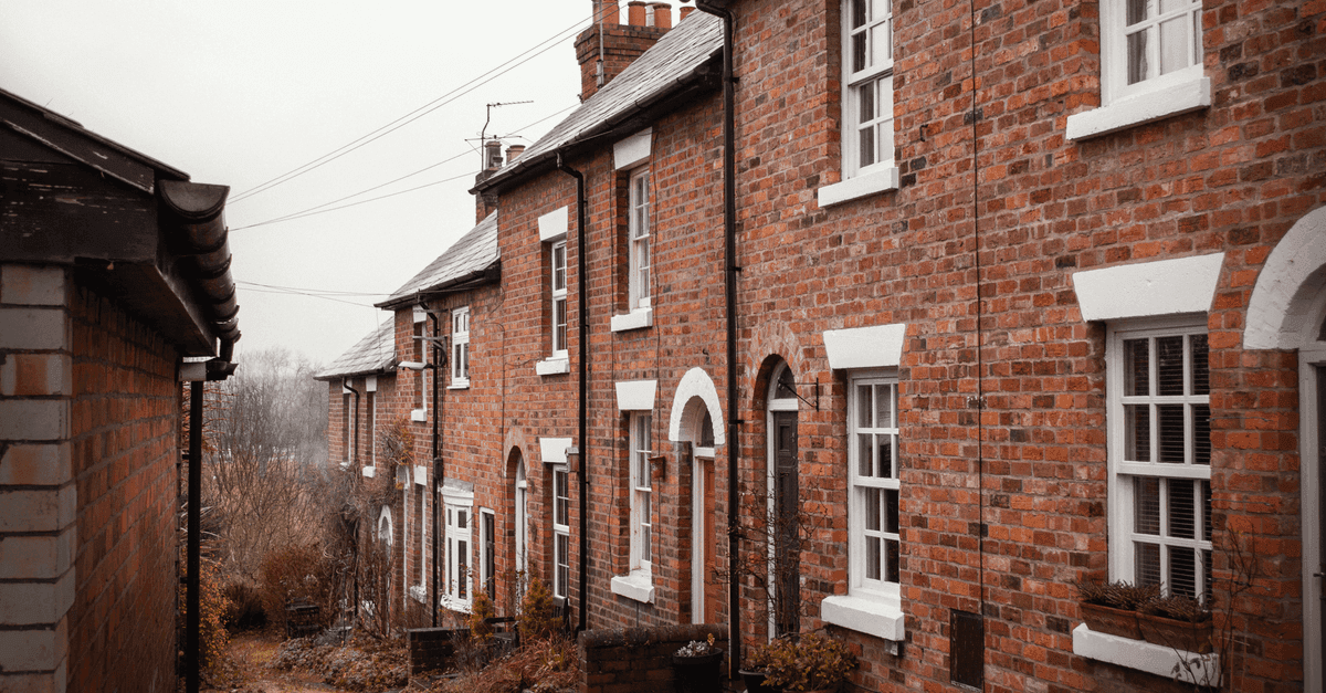 Picturesque view of traditional brick houses lining a quaint alley in Shrewsbury, England.
