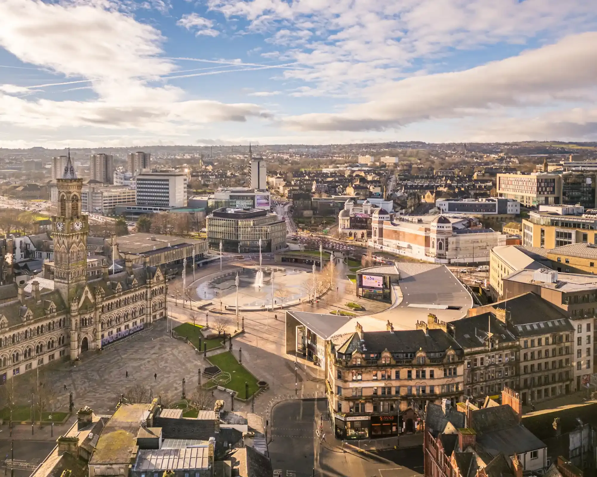 Aerial view of City Park in Bradford, with City Hall’s clock tower, the Mirror Pool fountain and the Alhambra Theatre.