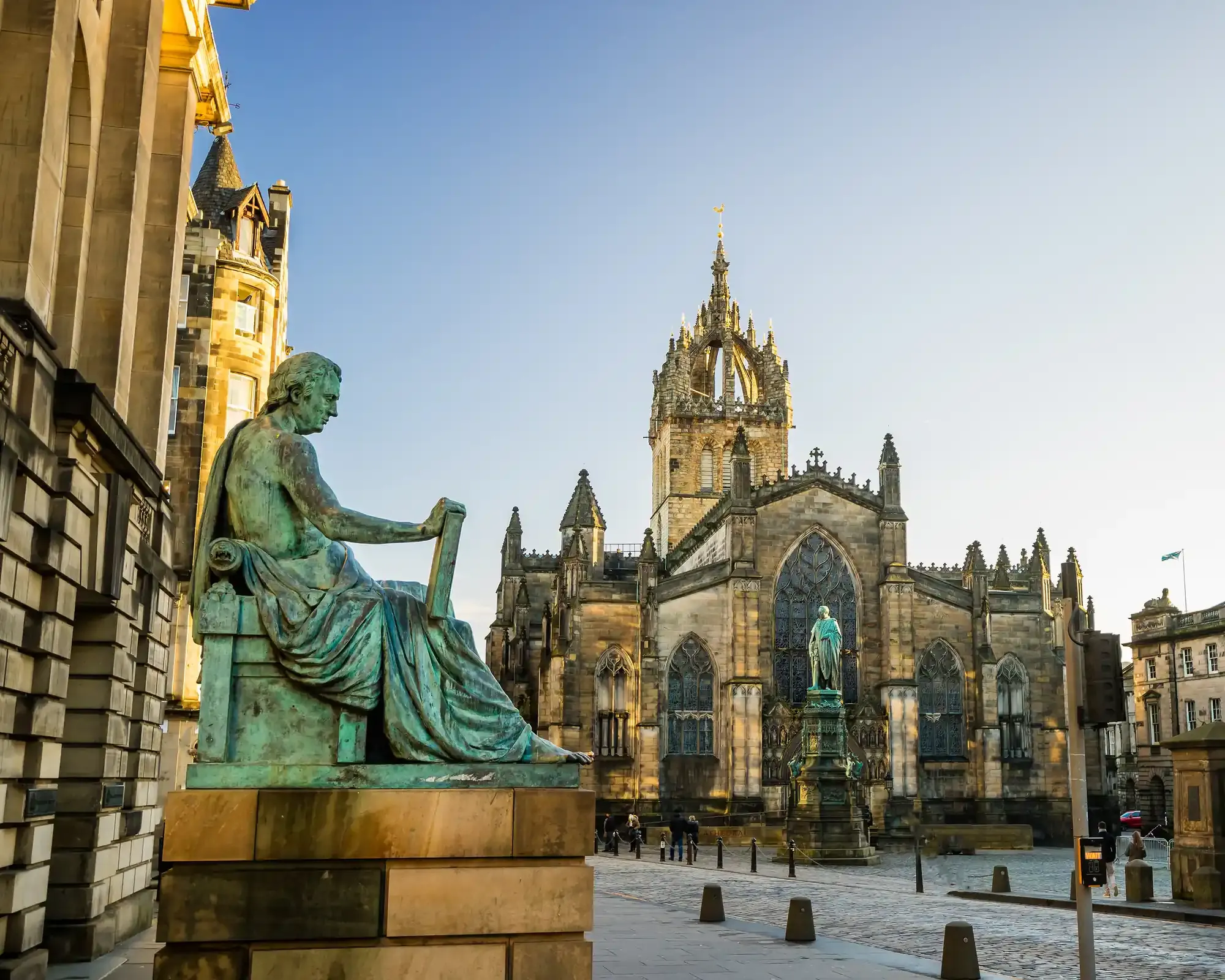 St Giles’ Cathedral on Edinburgh’s Royal Mile, with the David Hume statue in front. The crop is moved left so the statue fits fully and nobody at the edge is cut in half.
