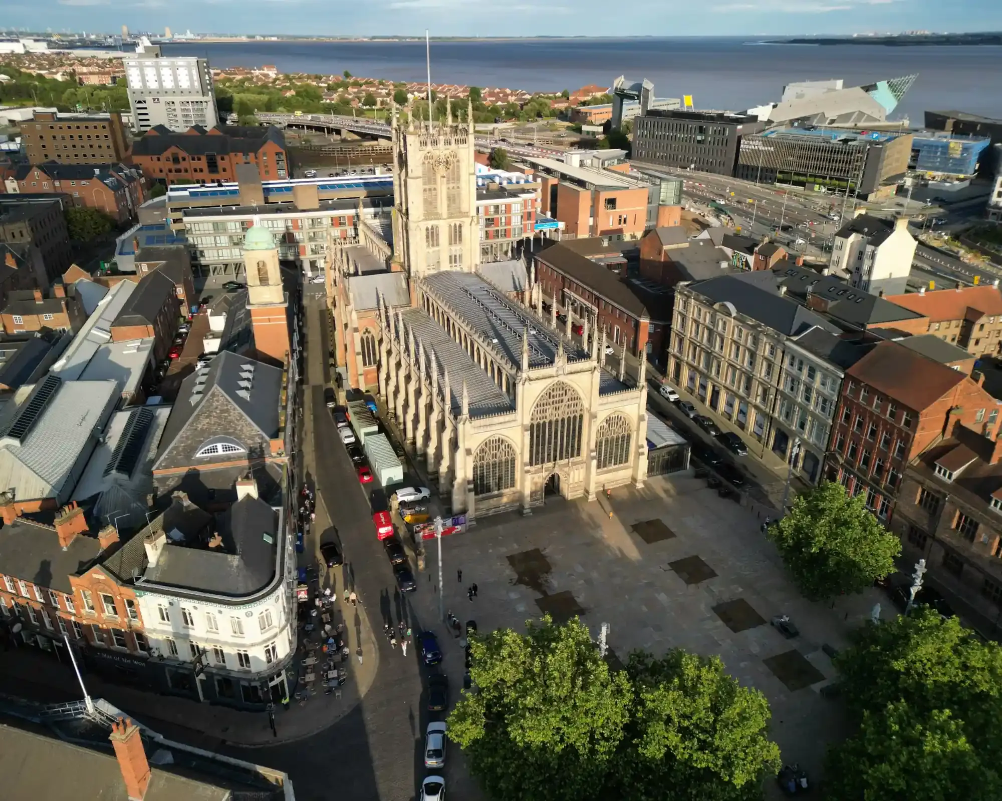 Aerial view of Hull Minster and Trinity Square, with The Deep and the Humber Estuary beyond.
