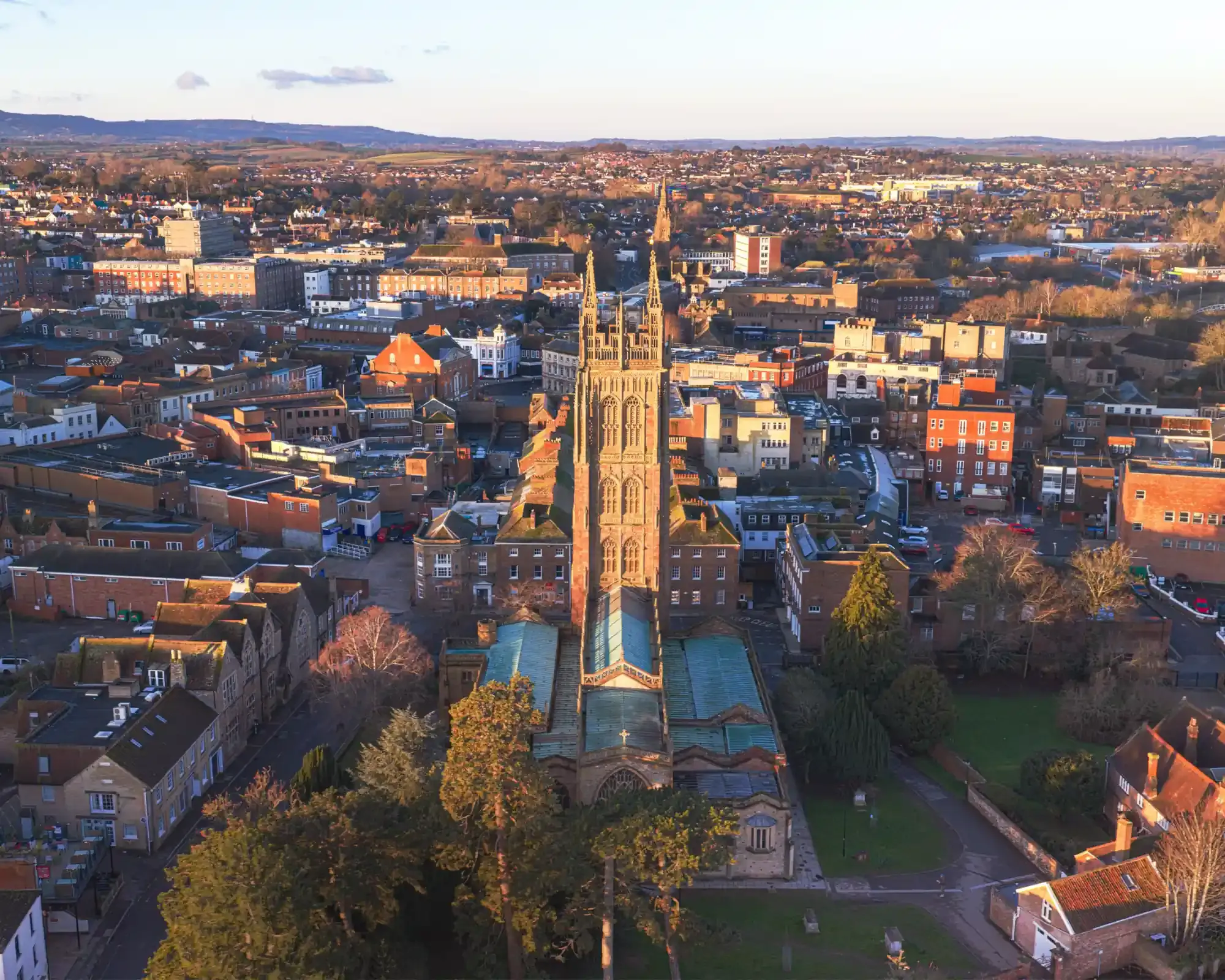 Aerial view of St Mary Magdalene Church’s tower in Taunton town centre, with the Blackdown Hills beyond.